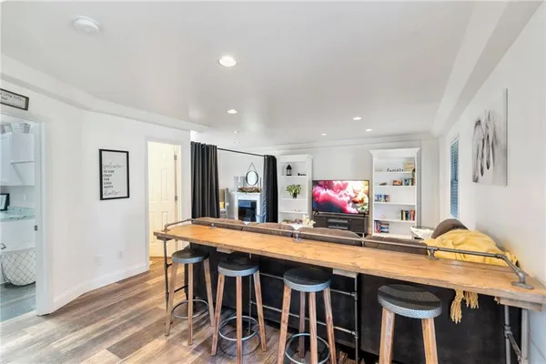 a kitchen with stainless steel appliances granite countertop a kitchen island a stove and a sink