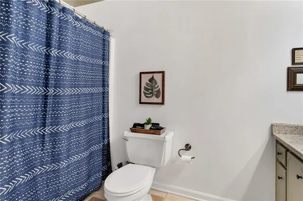 a white toilet sitting next to a shower curtain