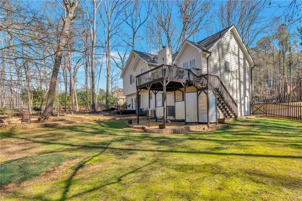 a swimming pool with outdoor seating and yard