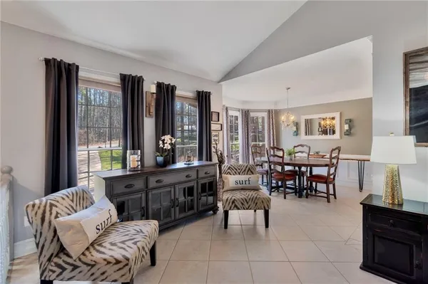a living room with furniture and large windows