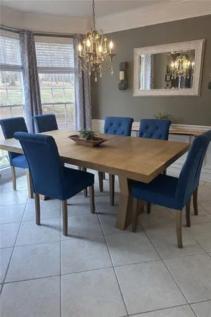 a view of a dining room with furniture and a chandelier