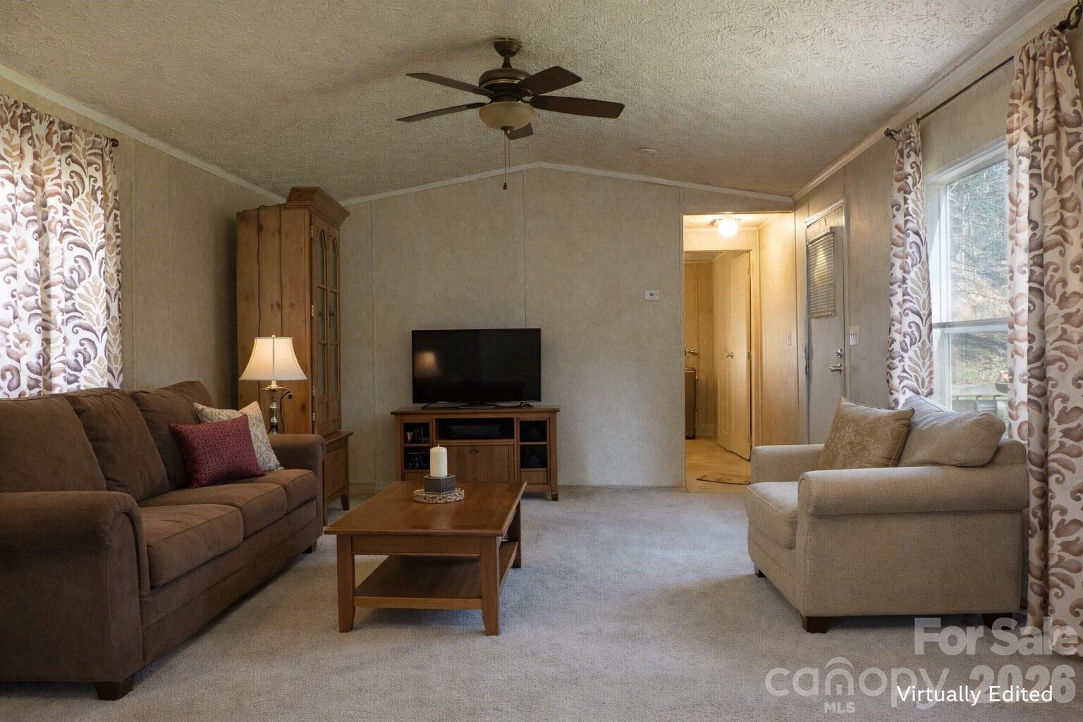 133 Birdie Watson Drive Rutherfordton, NC 28139 - Photo 6 of 9 a living room with furniture a ceiling fan and a flat screen tv