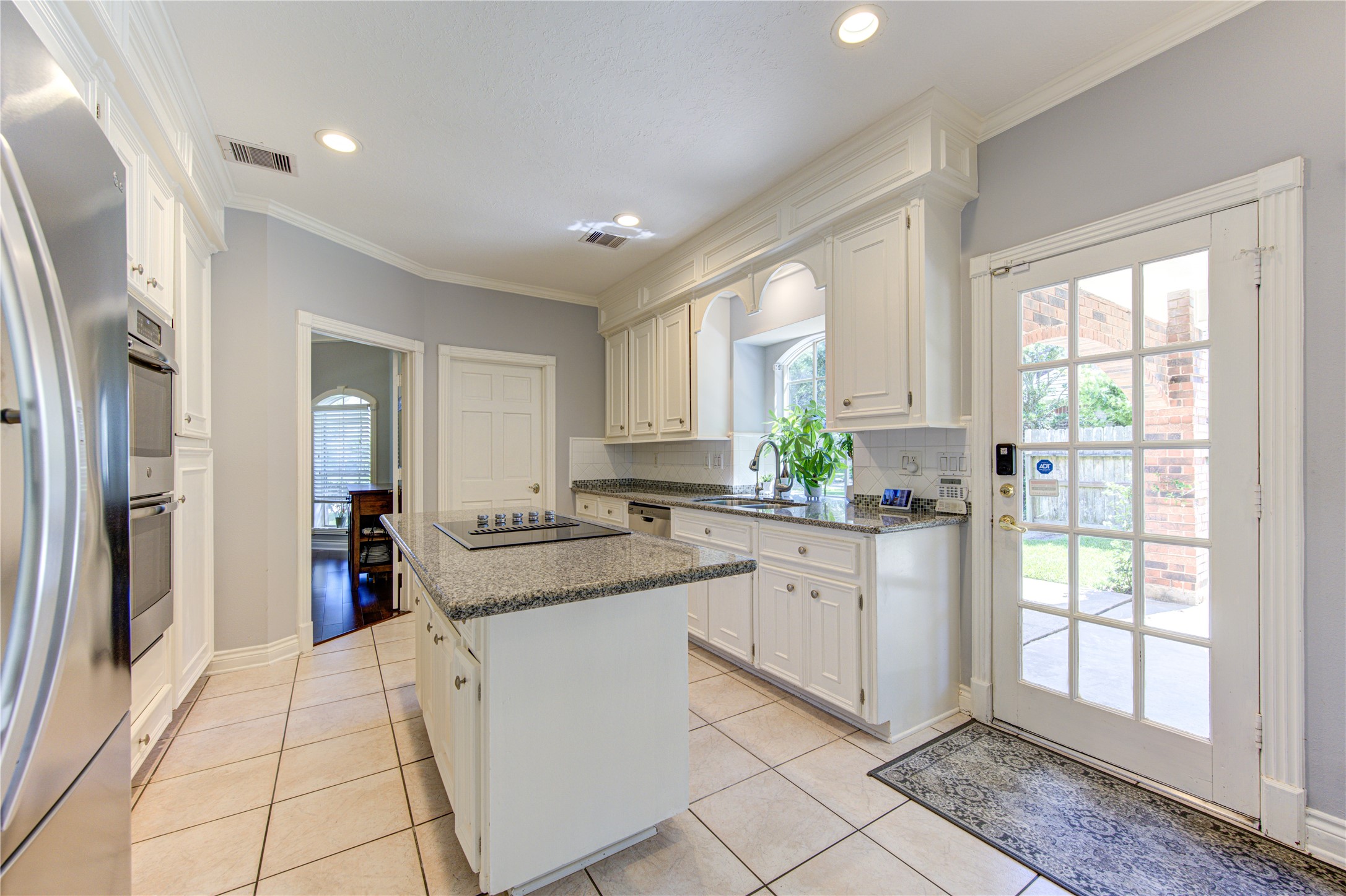 3622 Springhill Lane Sugar Land, TX 77479 - Photo 13 of 50 a large white kitchen with granite countertop a sink and white cabinets