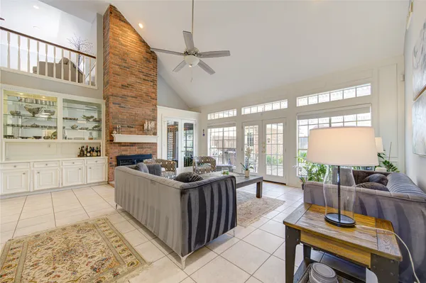 a living room with furniture a large window and kitchen view