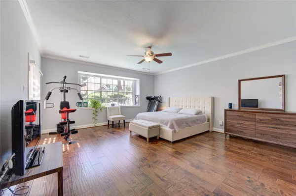a bedroom with bed and glass door