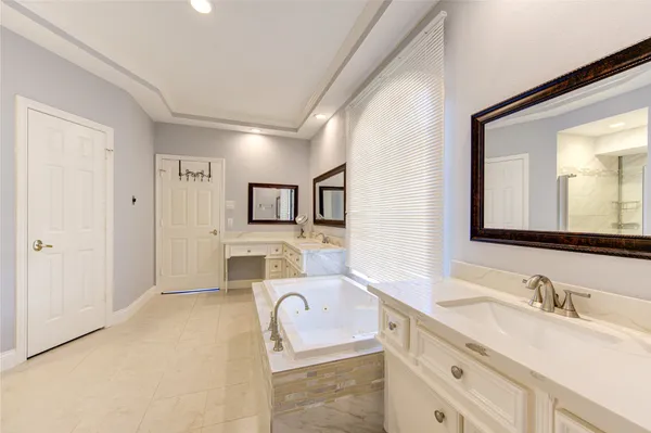 a bathroom with a granite countertop sink mirror and vanity