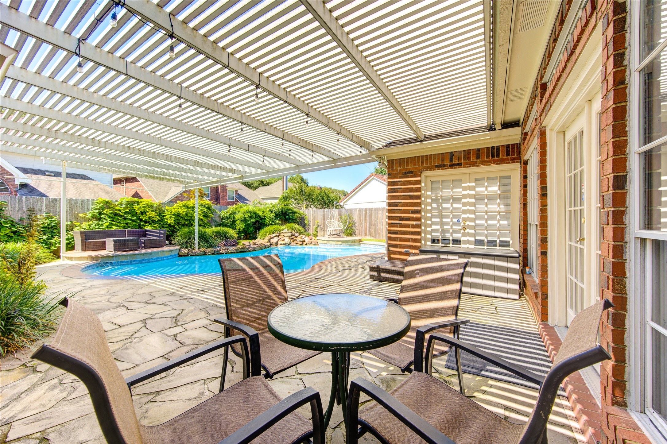 3622 Springhill Lane Sugar Land, TX 77479 - Photo 43 of 50 a view of a patio with table and chairs with wooden floor and fence