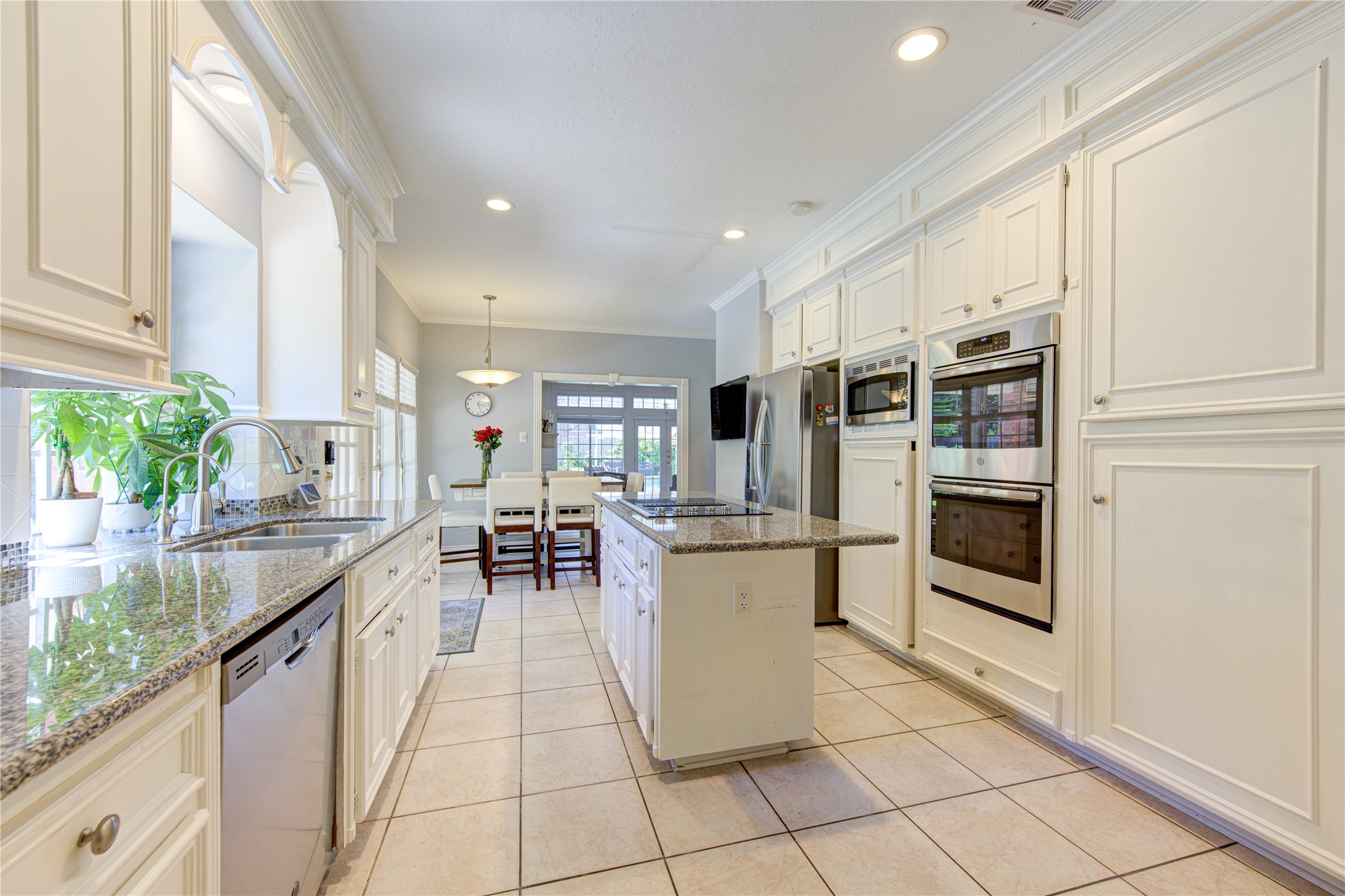 3622 Springhill Lane Sugar Land, TX 77479 - Photo 10 of 50 a kitchen with stainless steel appliances kitchen island granite countertop a refrigerator a stove and a sink with granite countertops