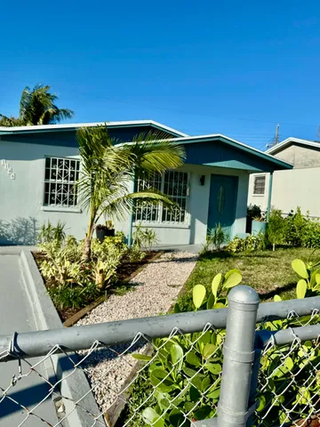 a front view of a house with sitting area