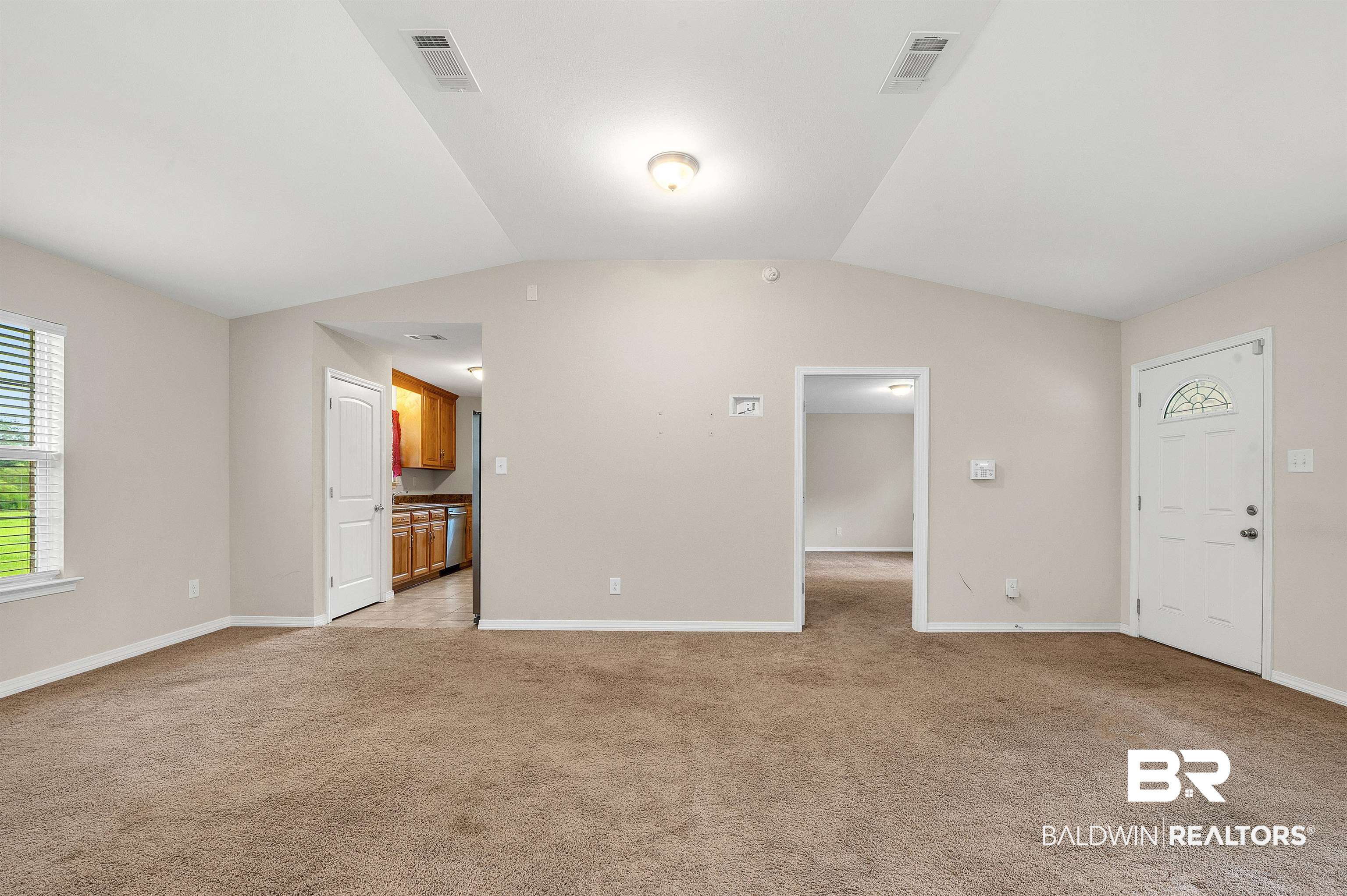 22810 Ard Road Robertsdale, AL 36567 - Photo 29 of 65 Unfurnished living room featuring light colored carpet and lofted ceiling