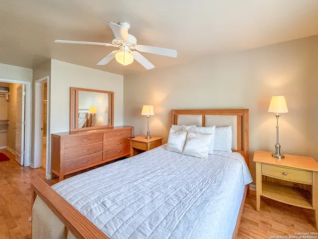 a bedroom with a bed window and a flat screen tv