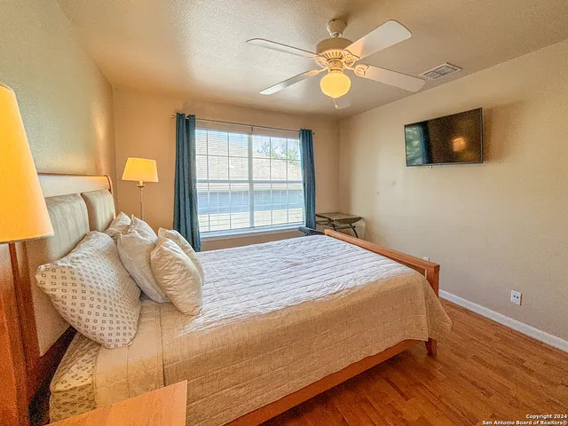 a bathroom with a double vanity sink a toilet and shower