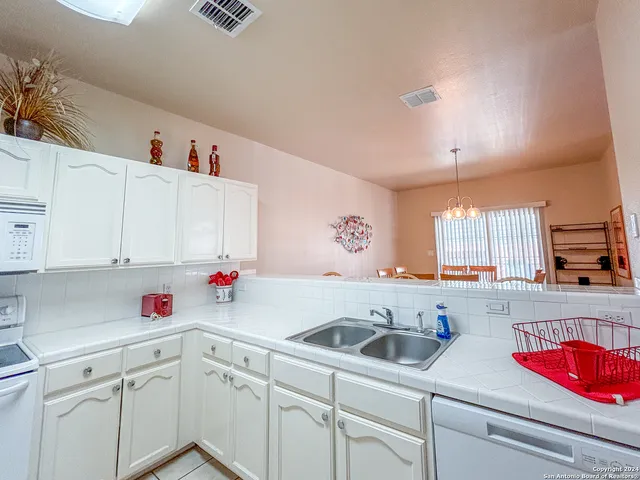 a dining room with furniture wooden floor and a chandelier