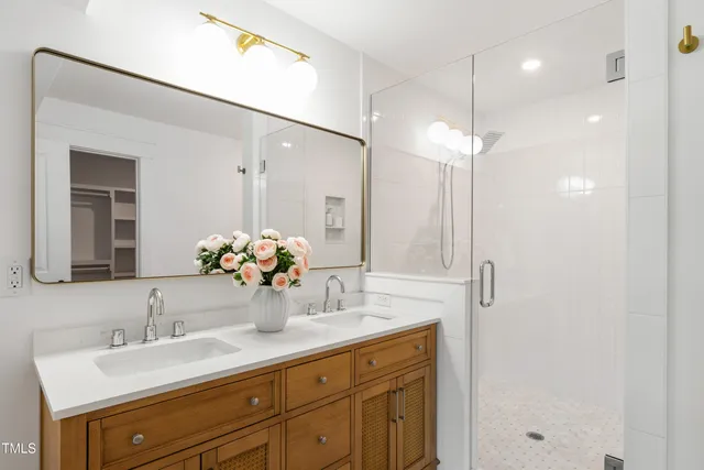 a bathroom with a sink double vanity granite and a mirror