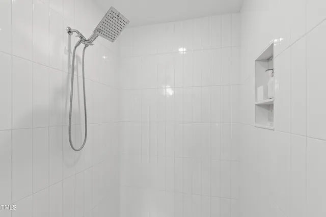 a bathroom with a glass shower door