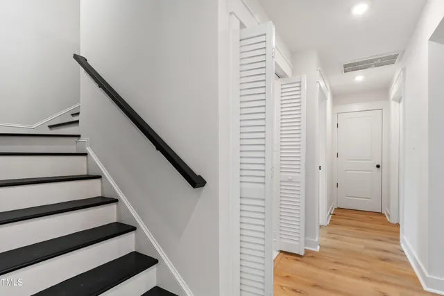 a view of a hallway with wooden floor and entryway