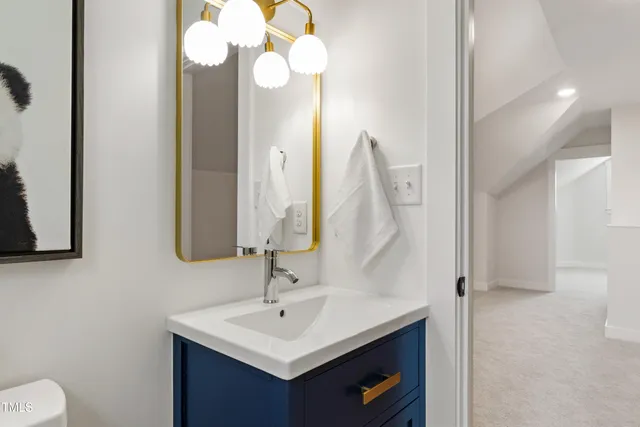 a bathroom with a sink vanity and a mirror