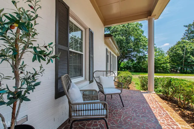 a view of balcony with furniture and garden
