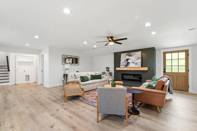 a living room with furniture a fireplace and a flat screen tv
