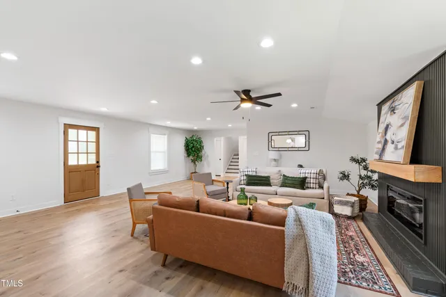 a living room with furniture fireplace and window