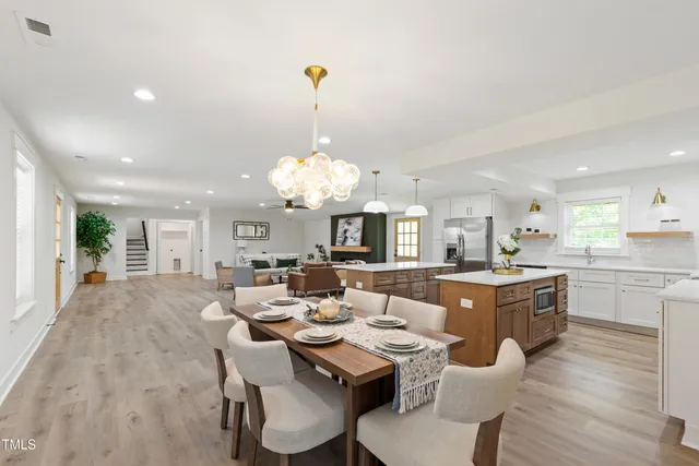 a large kitchen with a table and chairs