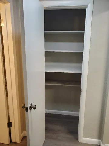 a view of walk in closet with empty racks