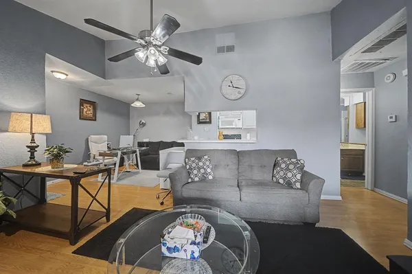 a living room with furniture and a chandelier