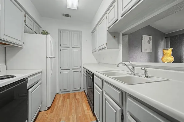 a kitchen with a sink and a refrigerator