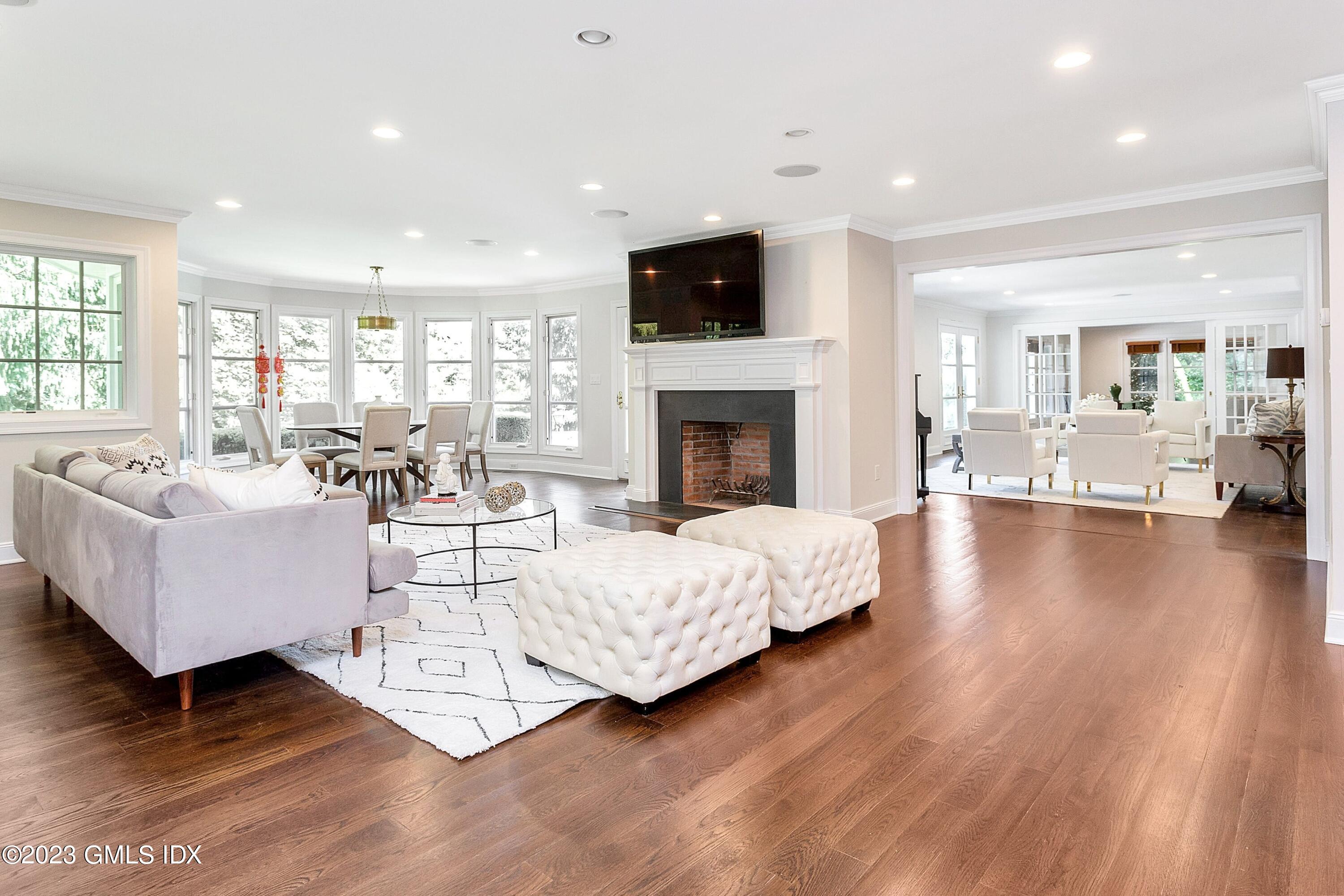 357 Round Hill Road Greenwich, CT 06831 - Photo 15 of 52 a living room with fireplace furniture and a wooden floor