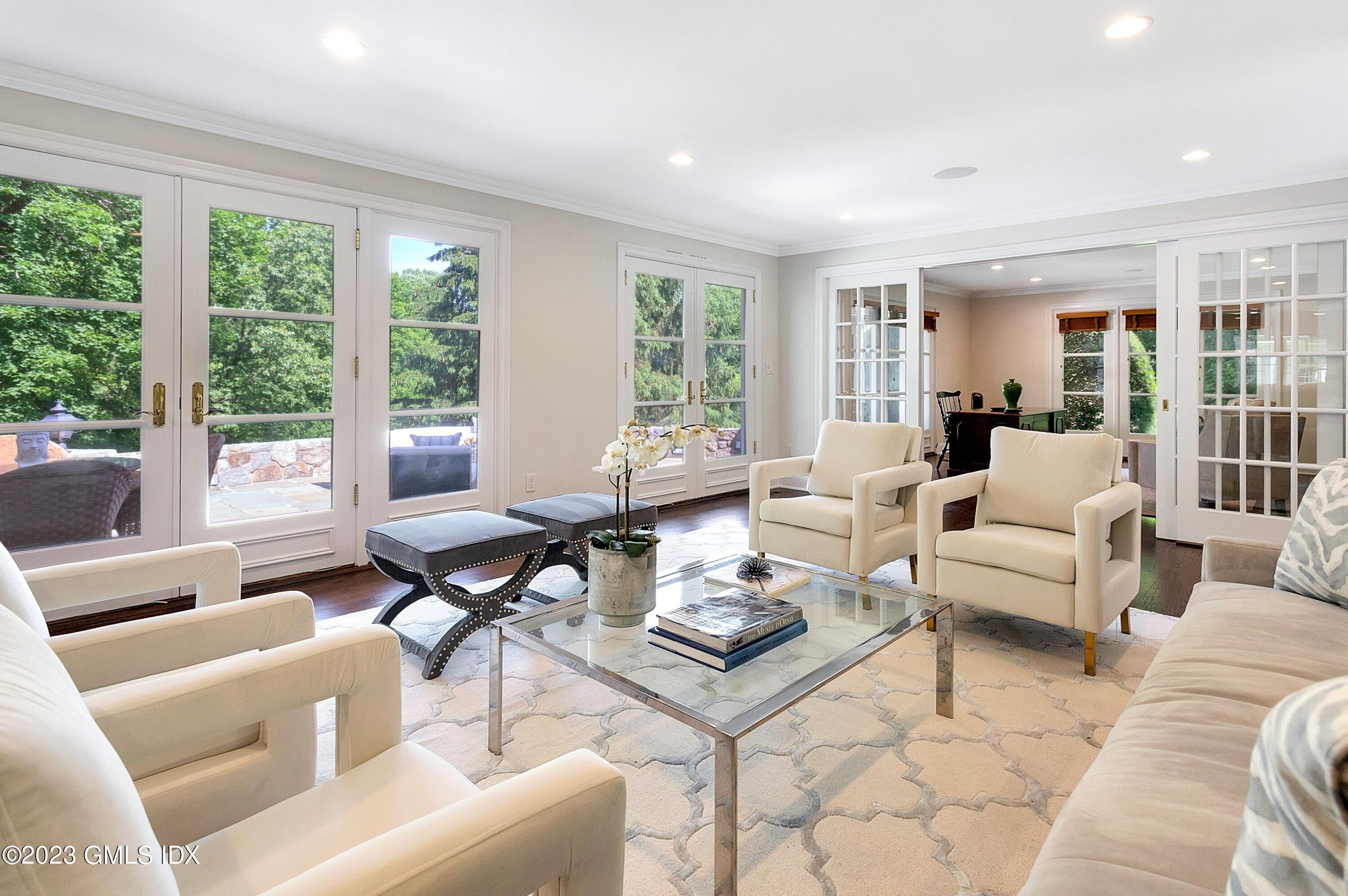 357 Round Hill Road Greenwich, CT 06831 - Photo 16 of 52 a living room with furniture and large windows
