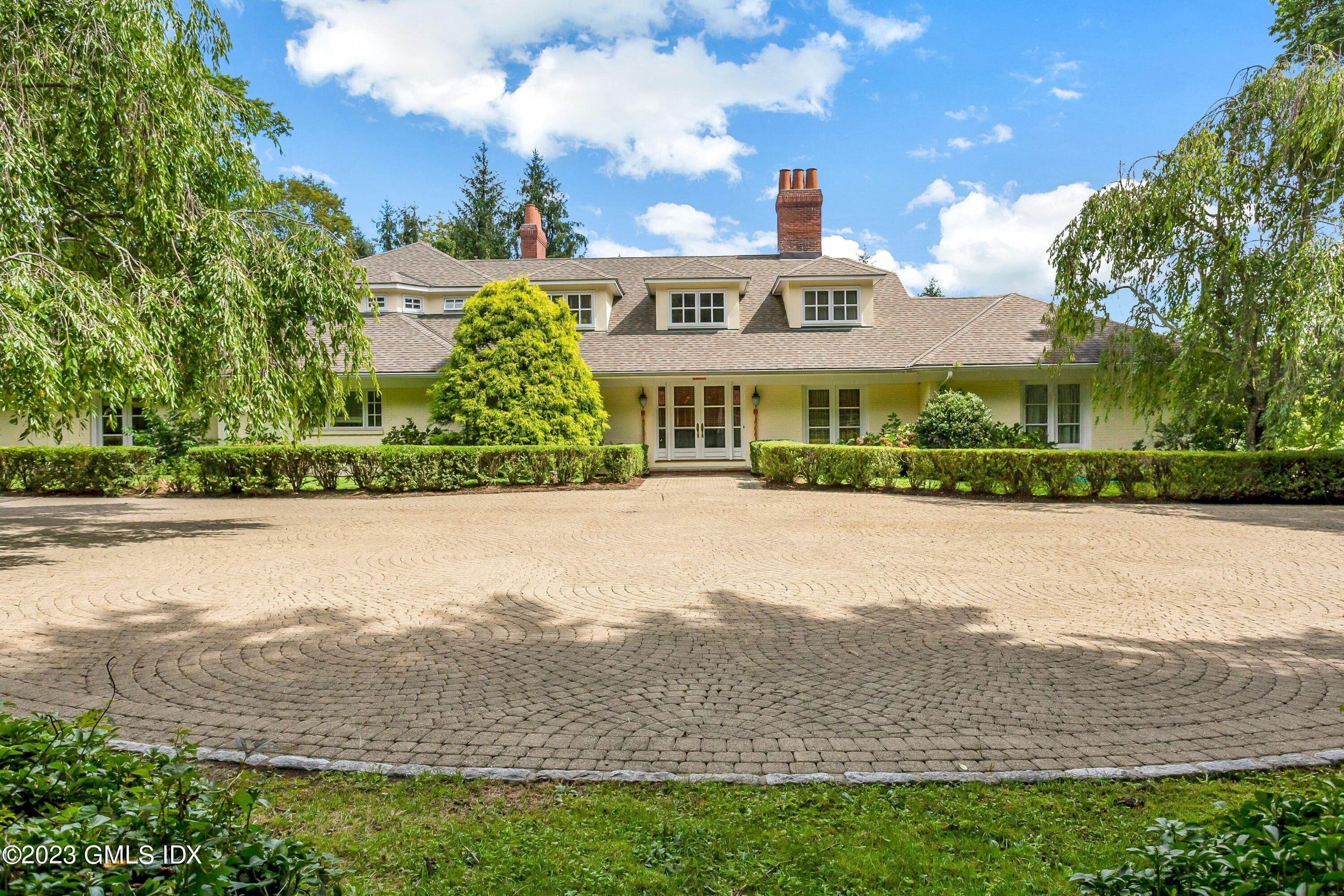 357 Round Hill Road Greenwich, CT 06831 - Photo 2 of 52 a view of multiple houses with a yard and lake view