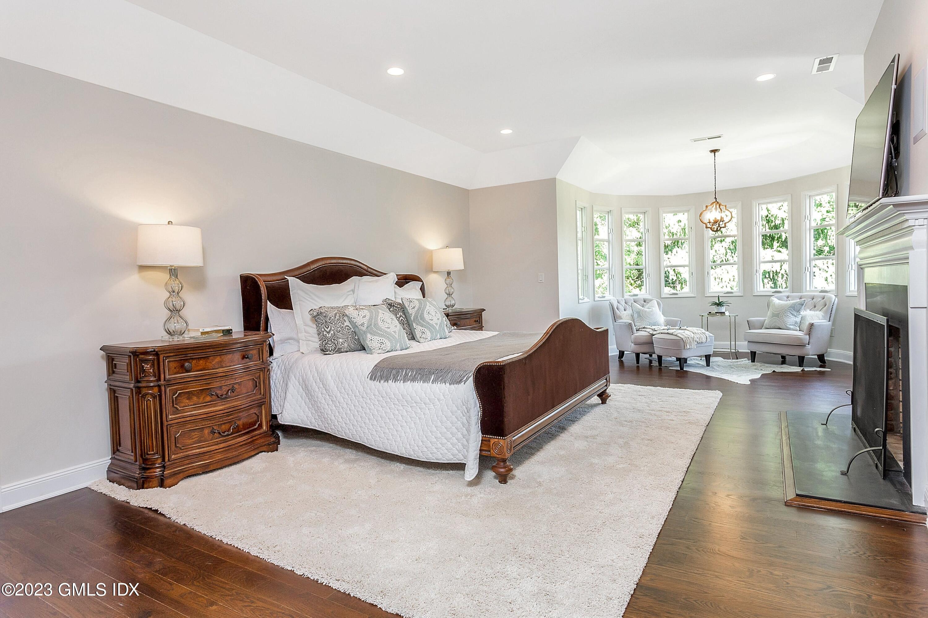 357 Round Hill Road Greenwich, CT 06831 - Photo 21 of 52 a living room with furniture fireplace and a large window