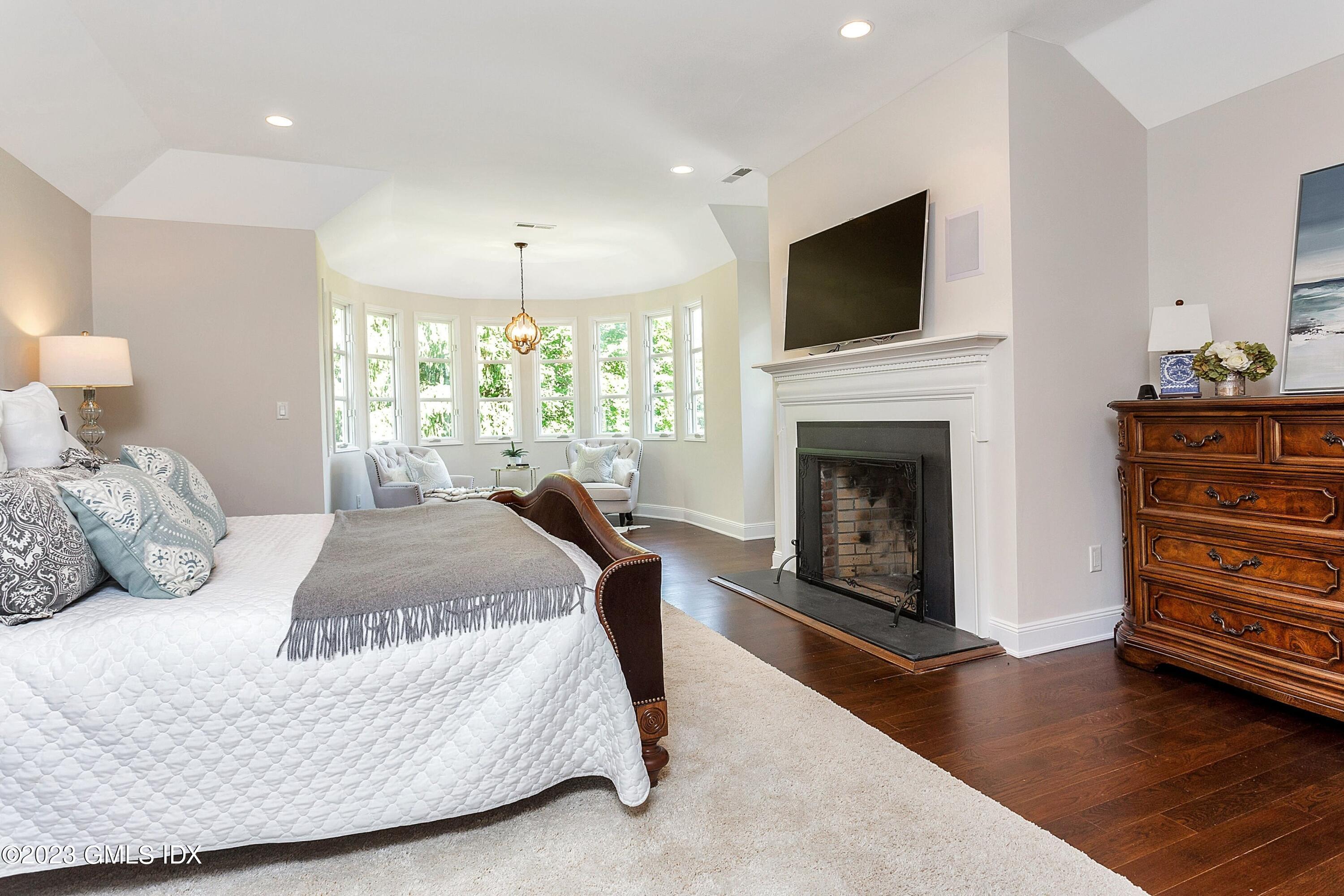 357 Round Hill Road Greenwich, CT 06831 - Photo 23 of 52 a bedroom with a bed and a flat screen tv