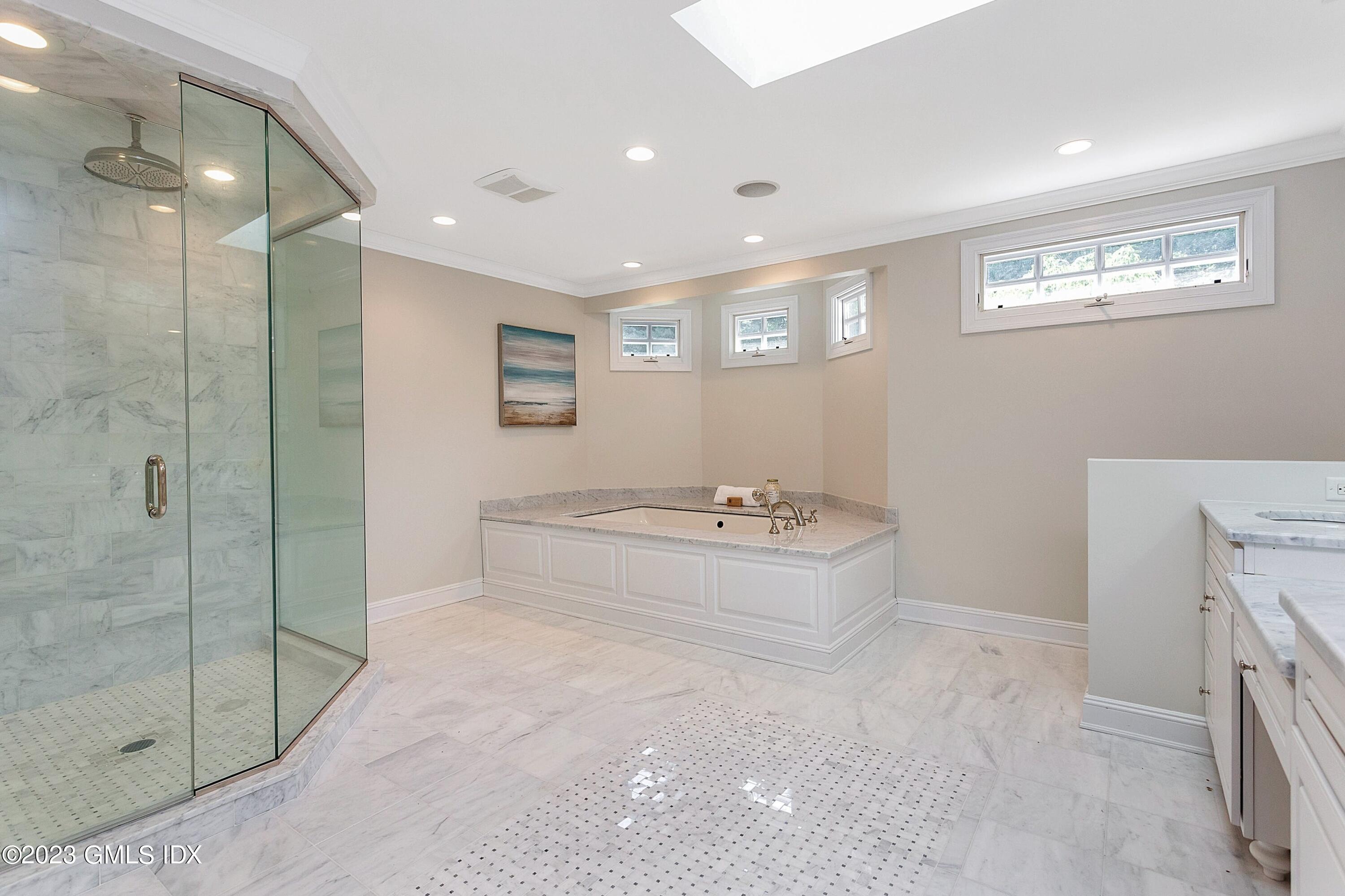 357 Round Hill Road Greenwich, CT 06831 - Photo 24 of 52 a bathroom with a bathtub and a shower