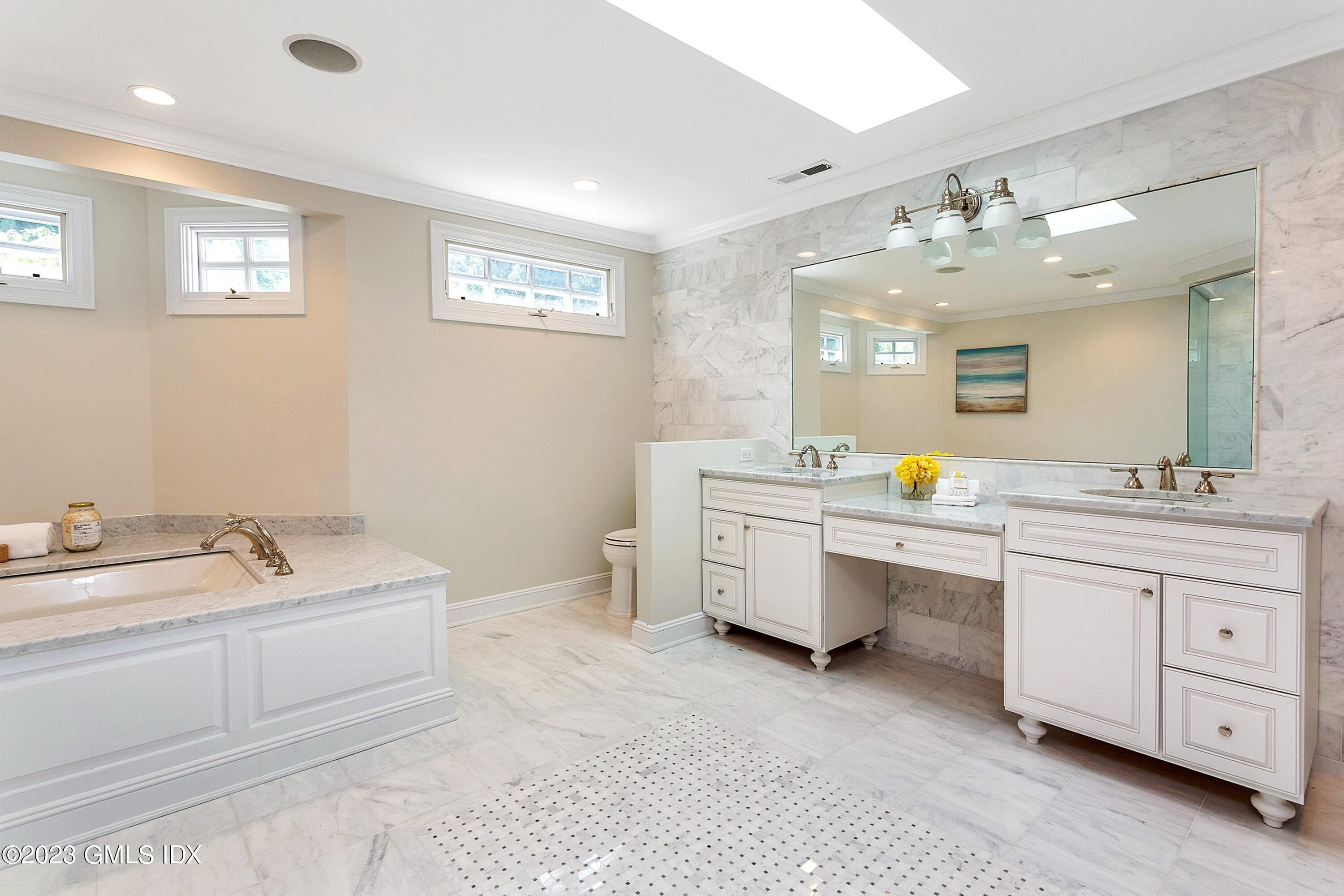 357 Round Hill Road Greenwich, CT 06831 - Photo 25 of 52 a spacious bathroom with a double vanity sink mirror and bathtub