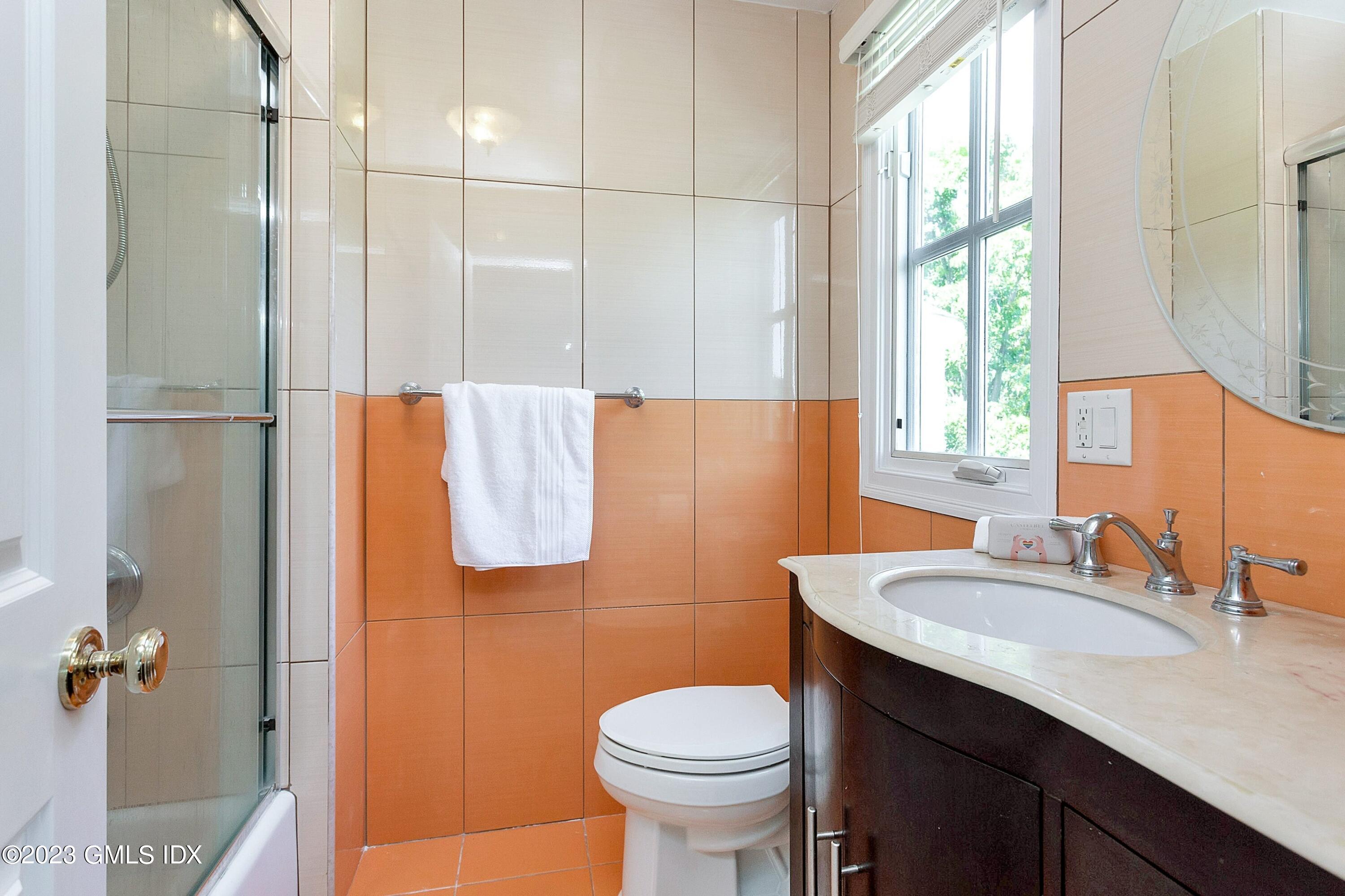 357 Round Hill Road Greenwich, CT 06831 - Photo 29 of 52 a bathroom with a sink toilet and a mirror