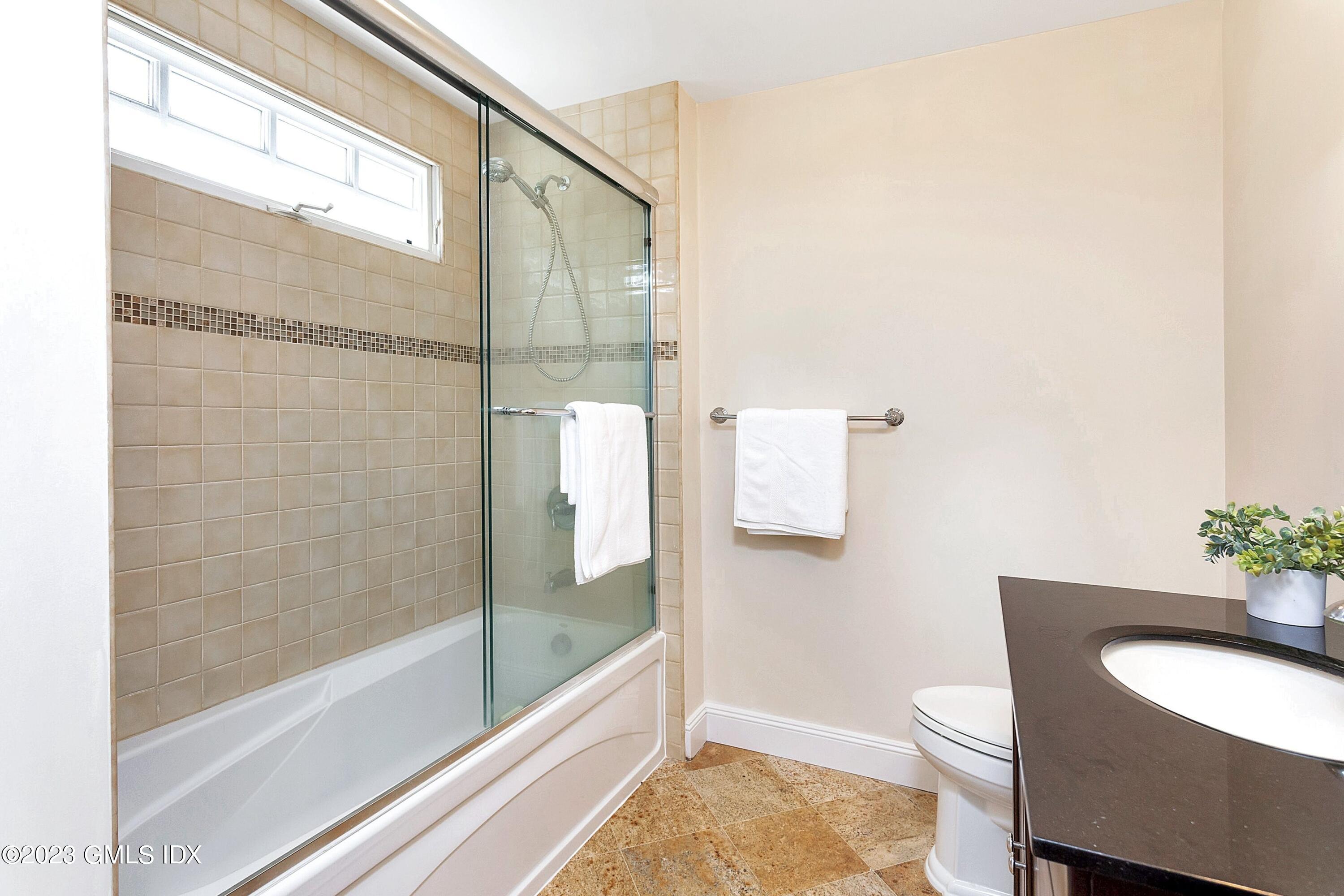 357 Round Hill Road Greenwich, CT 06831 - Photo 31 of 52 a bathroom with a granite countertop sink mirror vanity and toilet