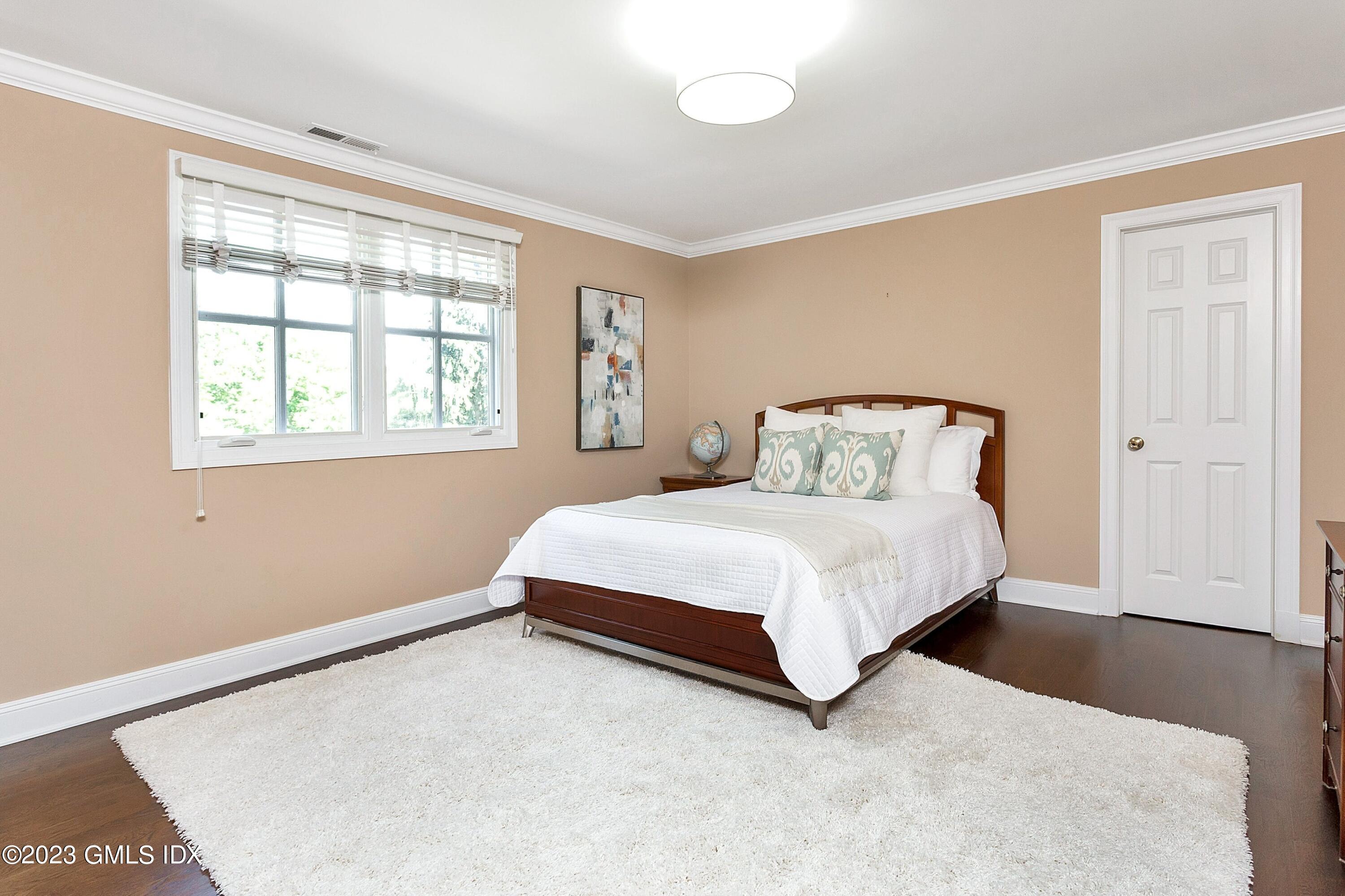 357 Round Hill Road Greenwich, CT 06831 - Photo 32 of 52 a bedroom with a bed and a window