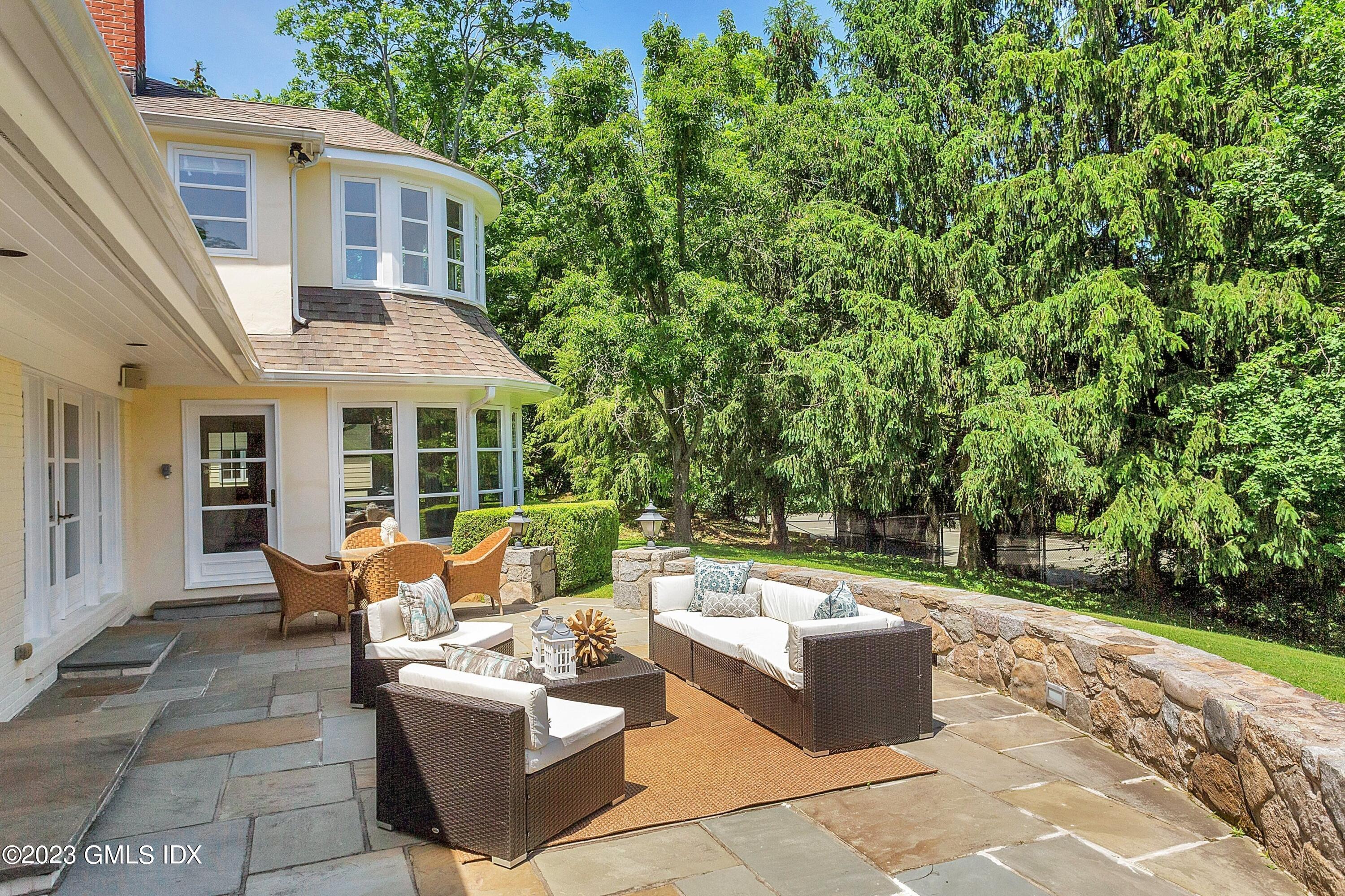 357 Round Hill Road Greenwich, CT 06831 - Photo 35 of 52 a view of house with a backyard and furniture