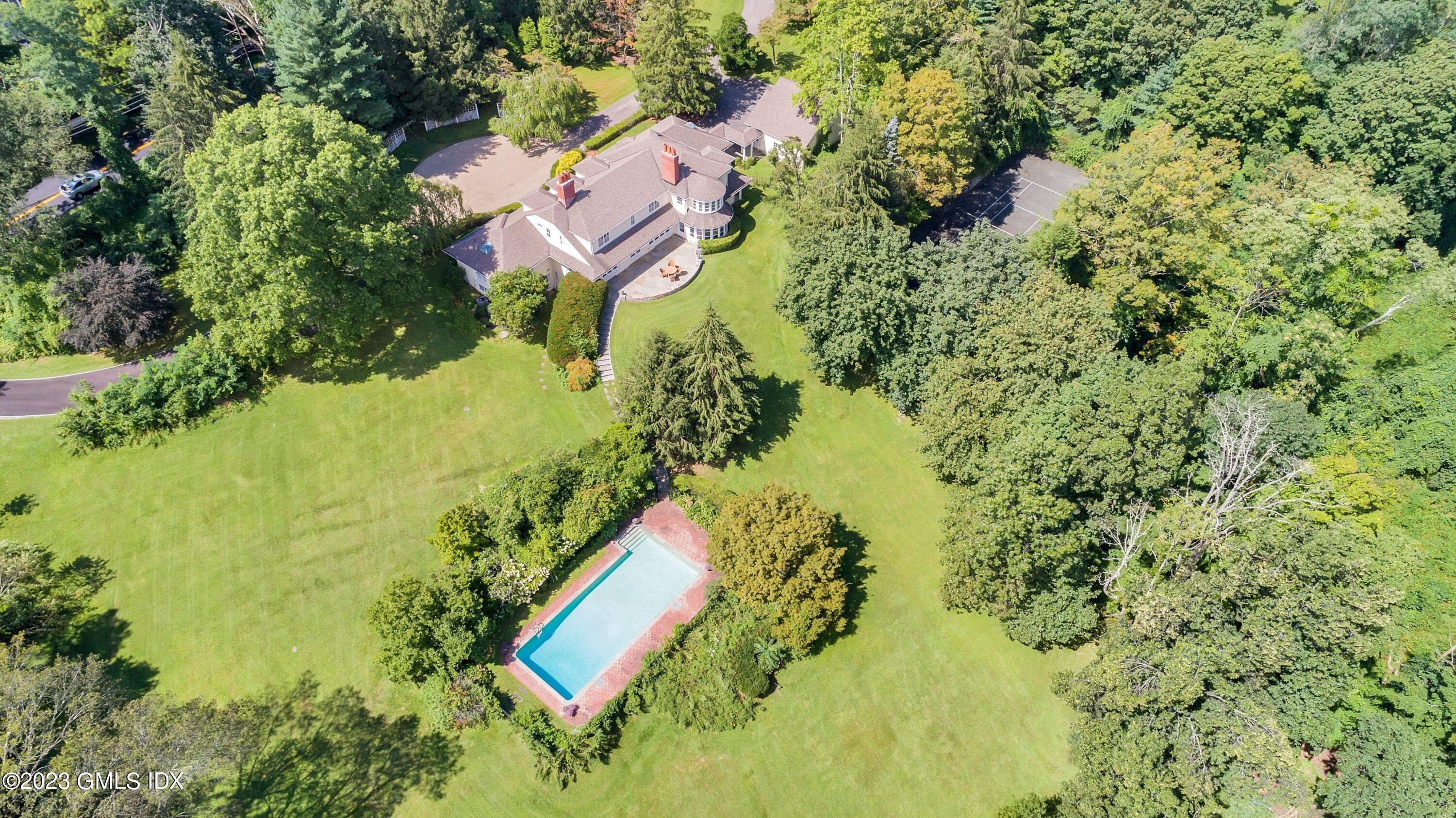 357 Round Hill Road Greenwich, CT 06831 - Photo 44 of 52 an aerial view of residential house with swimming pool and lawn chairs