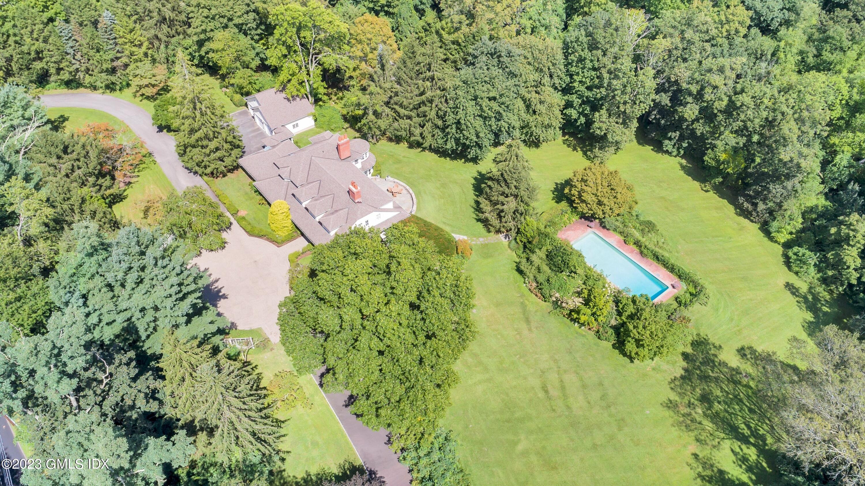 357 Round Hill Road Greenwich, CT 06831 - Photo 46 of 52 an aerial view of residential houses with outdoor space and trees