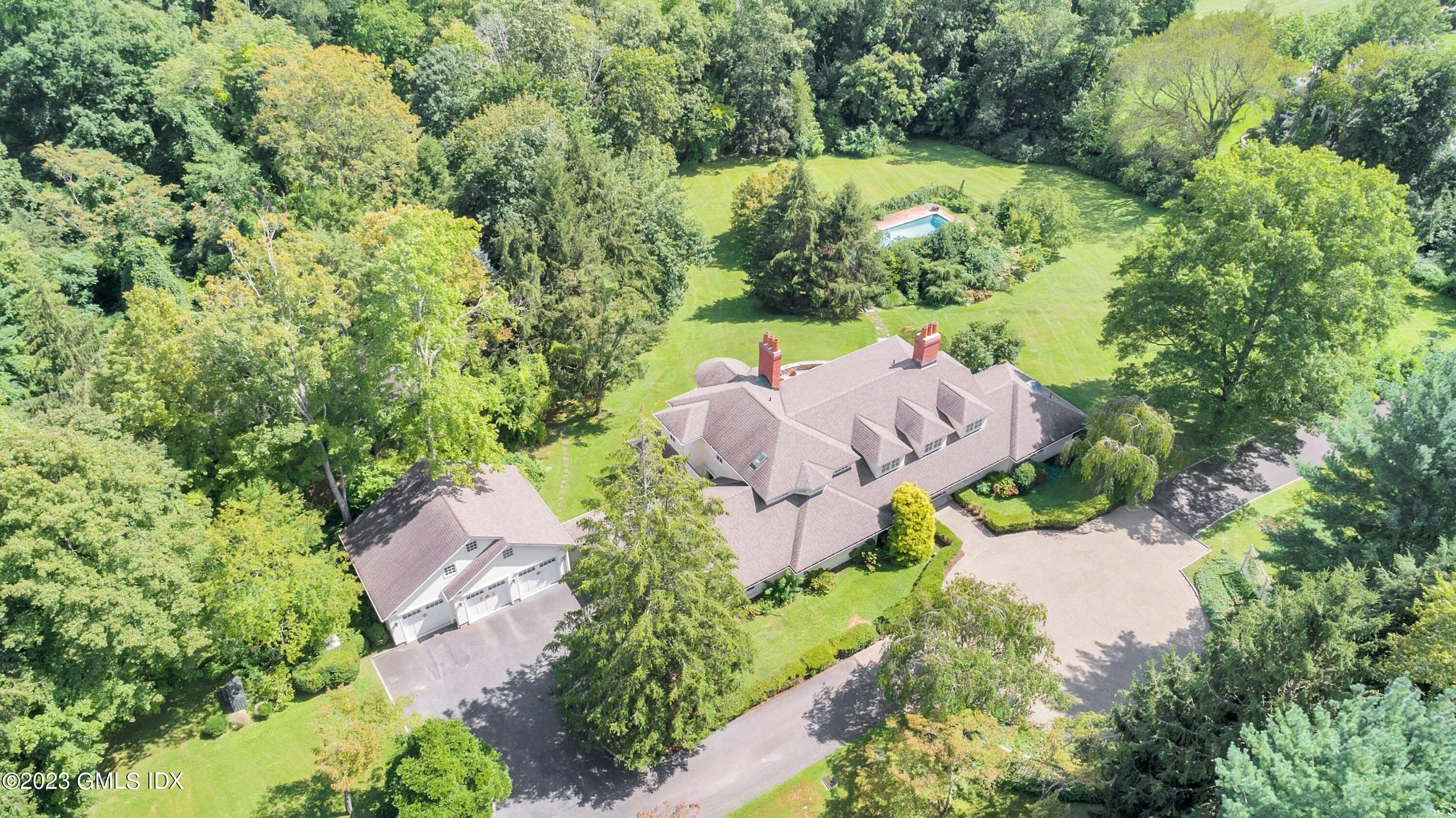 357 Round Hill Road Greenwich, CT 06831 - Photo 47 of 52 an aerial view of a house with a yard and outdoor seating