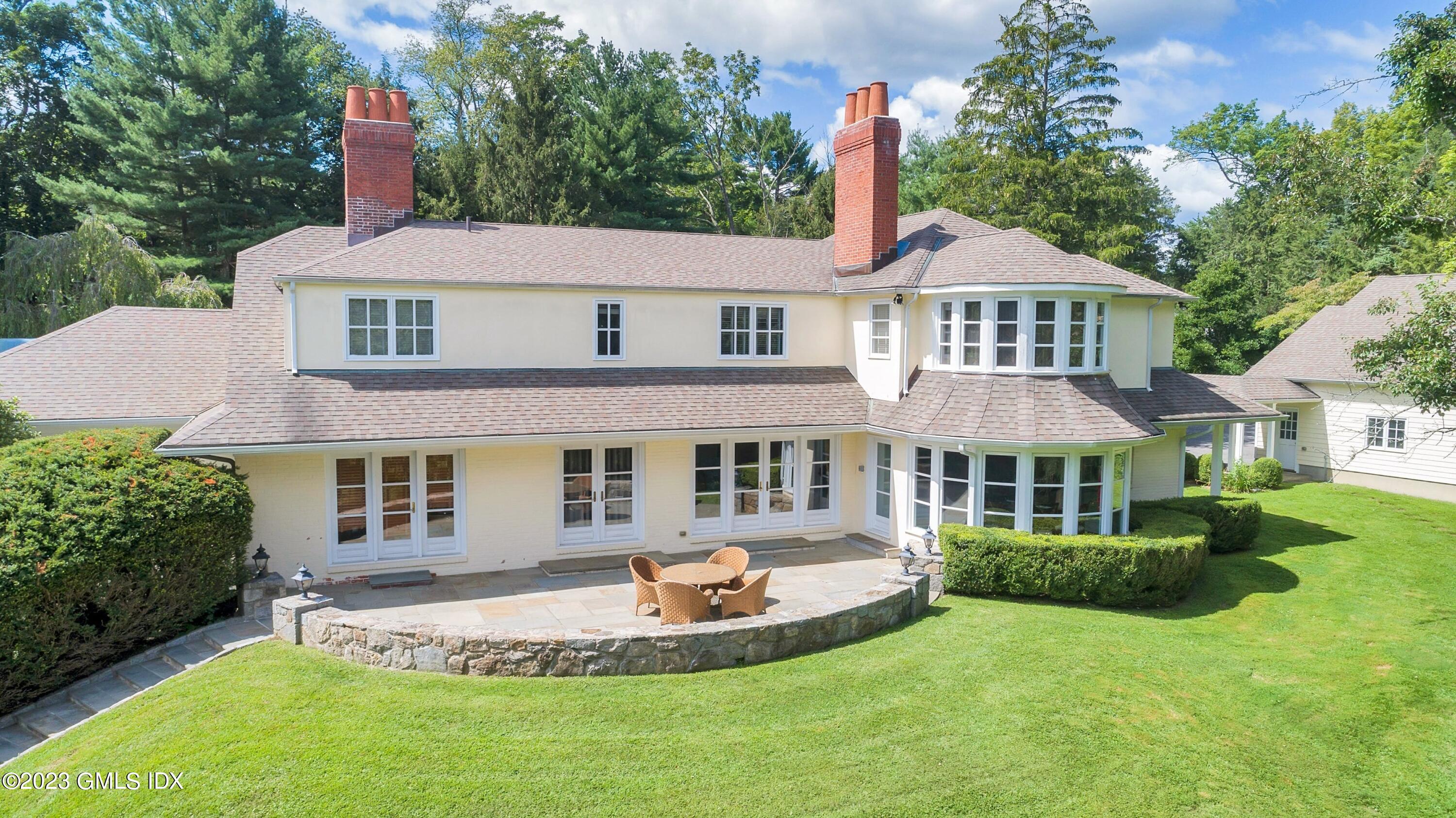 357 Round Hill Road Greenwich, CT 06831 - Photo 48 of 52 a front view of a house with a yard
