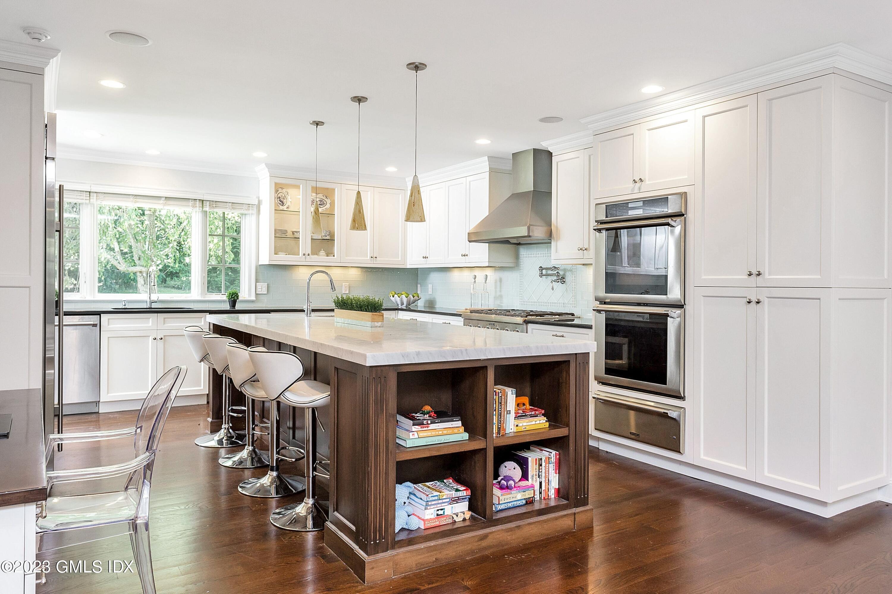 357 Round Hill Road Greenwich, CT 06831 - Photo 7 of 52 a kitchen with stainless steel appliances granite countertop a stove and a refrigerator