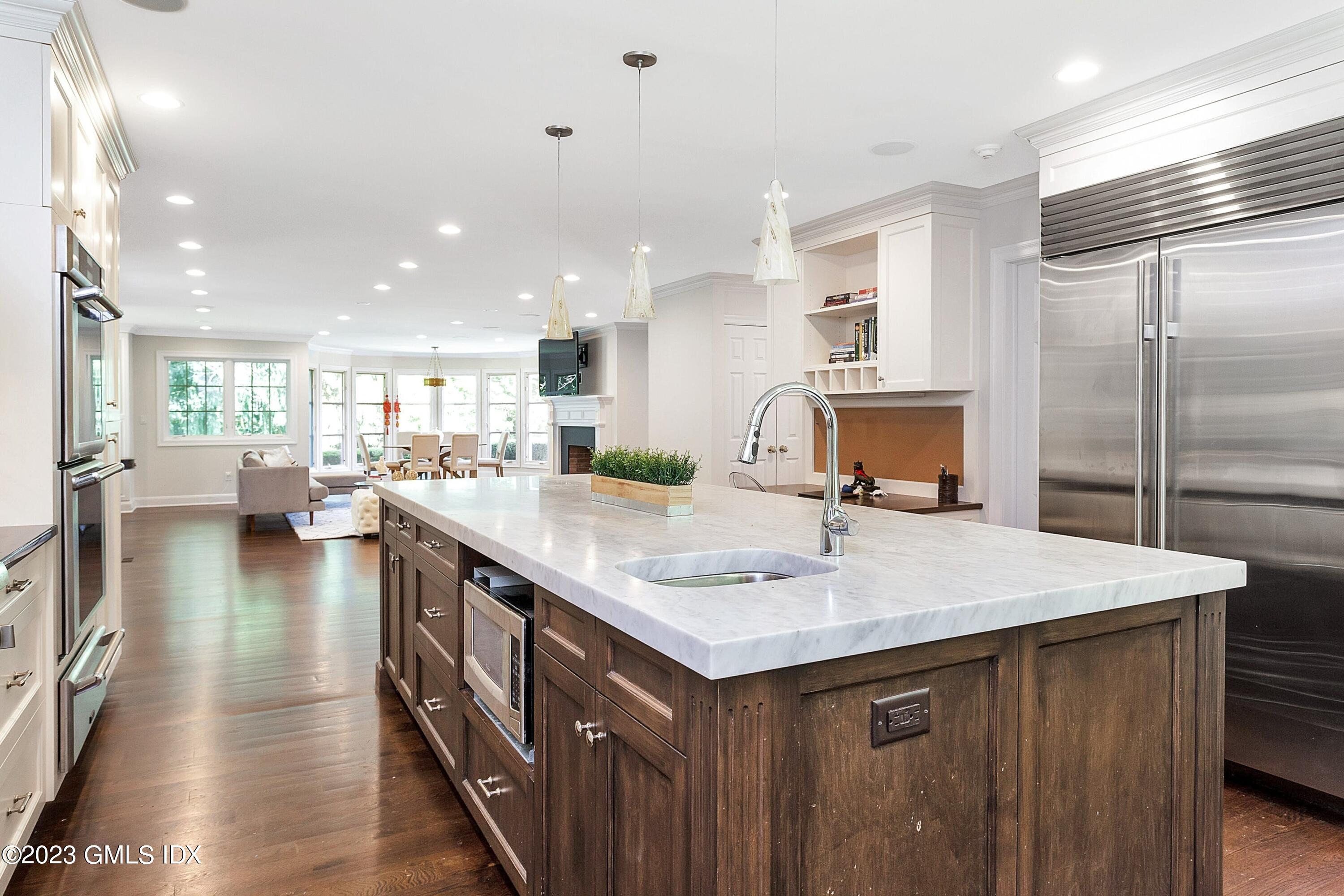 357 Round Hill Road Greenwich, CT 06831 - Photo 10 of 52 a kitchen with counter top space sink stove and refrigerator
