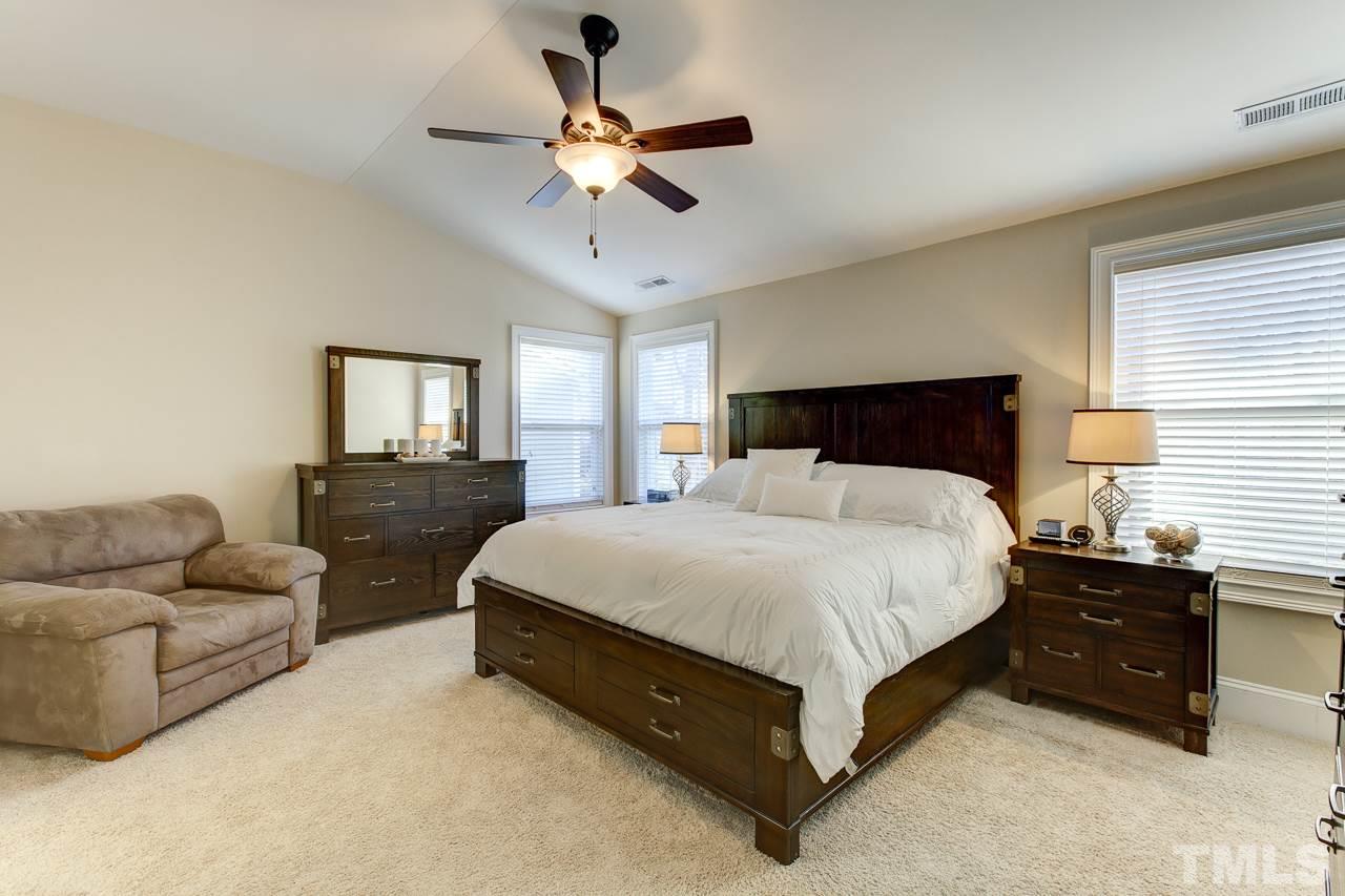 7319 Litchford Road Raleigh, NC 27615 - Photo 13 of 25 a spacious bedroom with a bed and ceiling fan