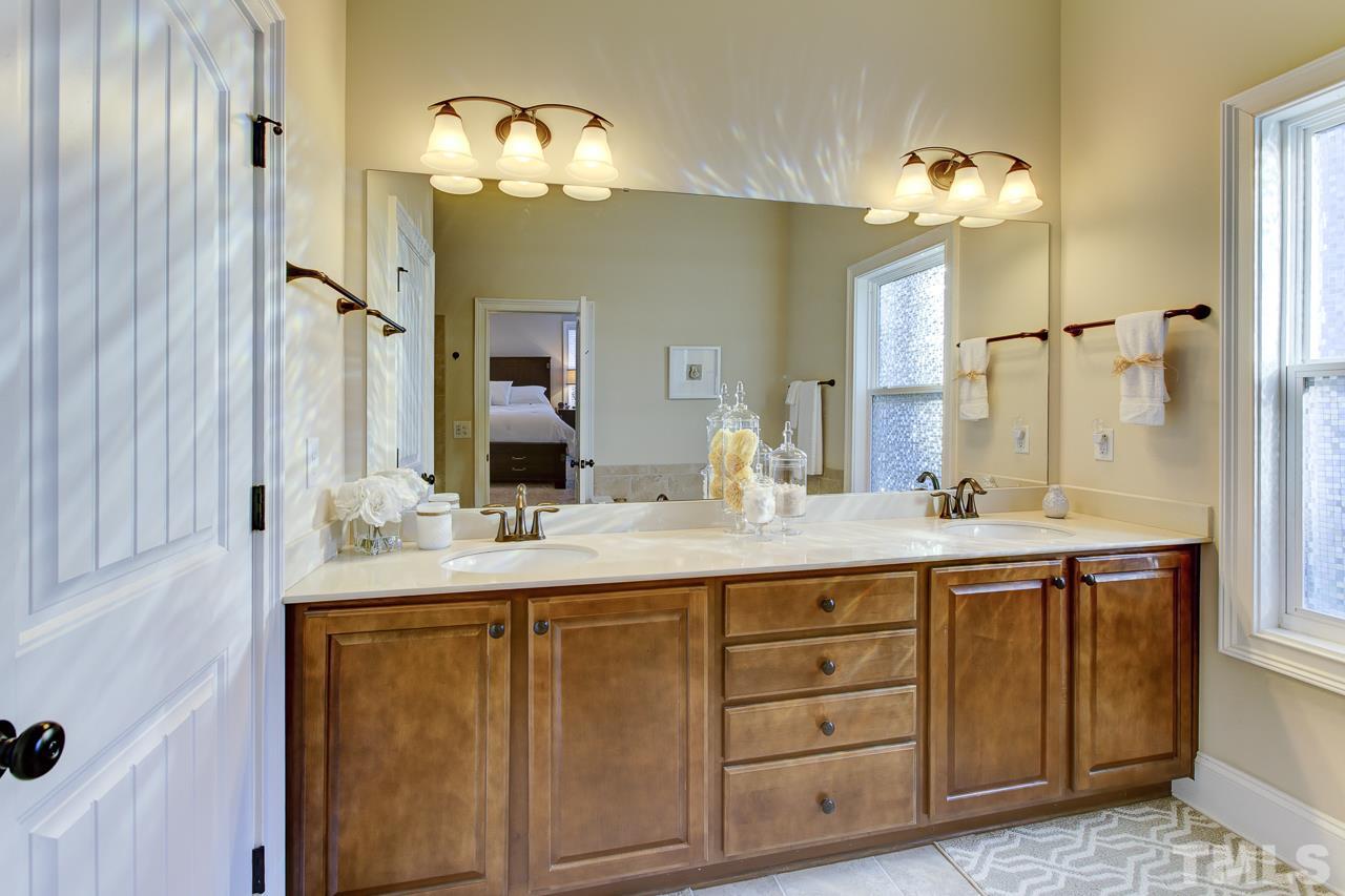 7319 Litchford Road Raleigh, NC 27615 - Photo 14 of 25 a bathroom with a double vanity sink and a mirror