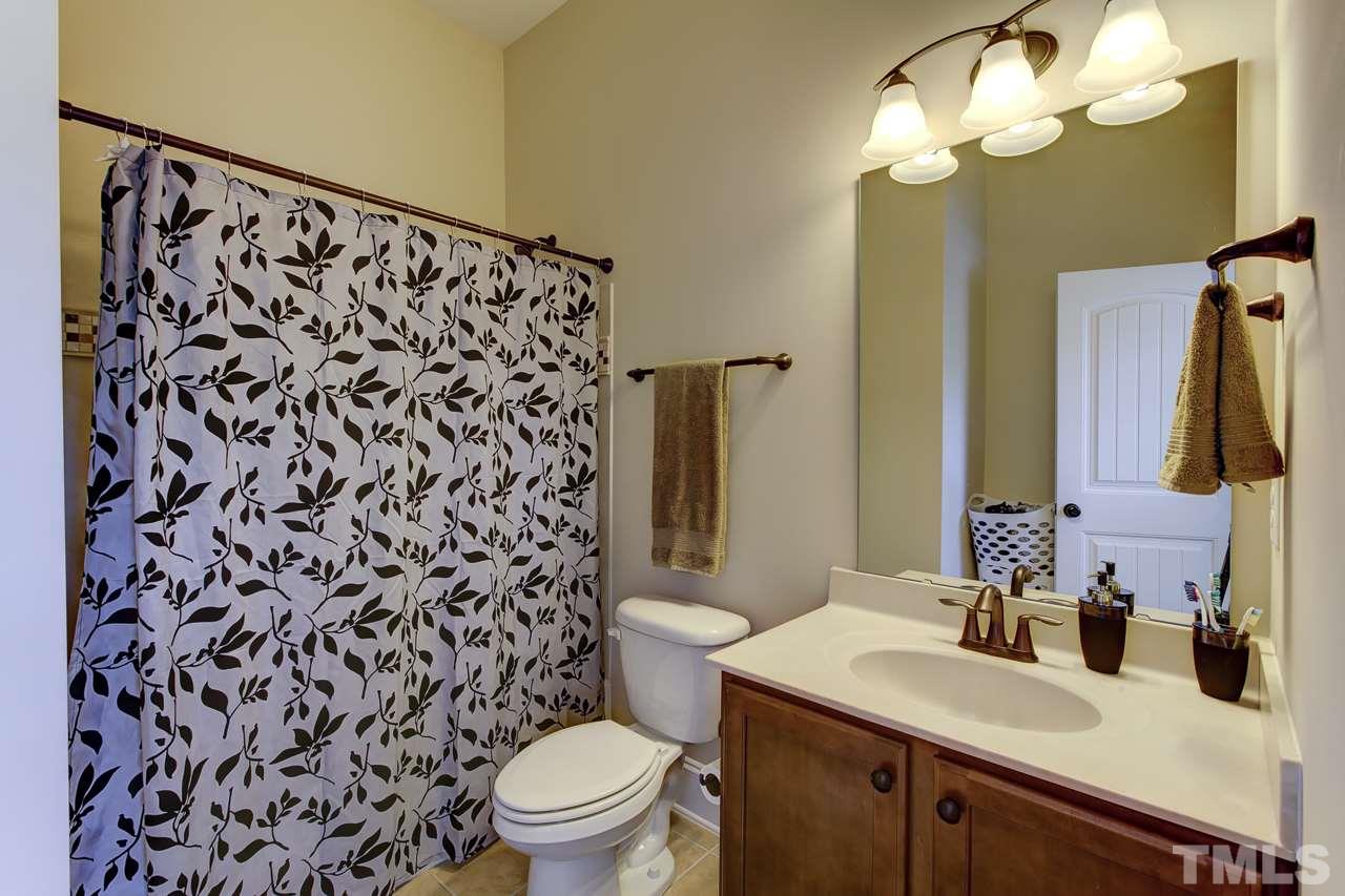 7319 Litchford Road Raleigh, NC 27615 - Photo 20 of 25 a bathroom with a sink and a mirror
