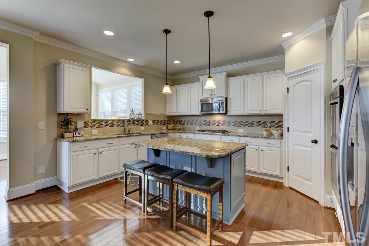 7319 Litchford Road Raleigh, NC 27615 - Photo 3 of 25 a kitchen with stainless steel appliances granite countertop a sink a stove a refrigerator and chairs