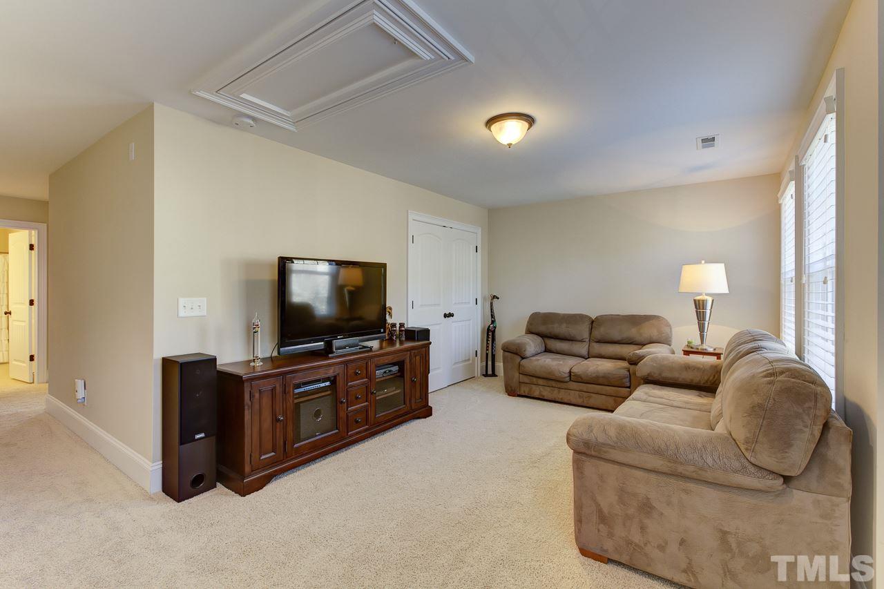 7319 Litchford Road Raleigh, NC 27615 - Photo 21 of 25 a living room with furniture and a flat screen tv
